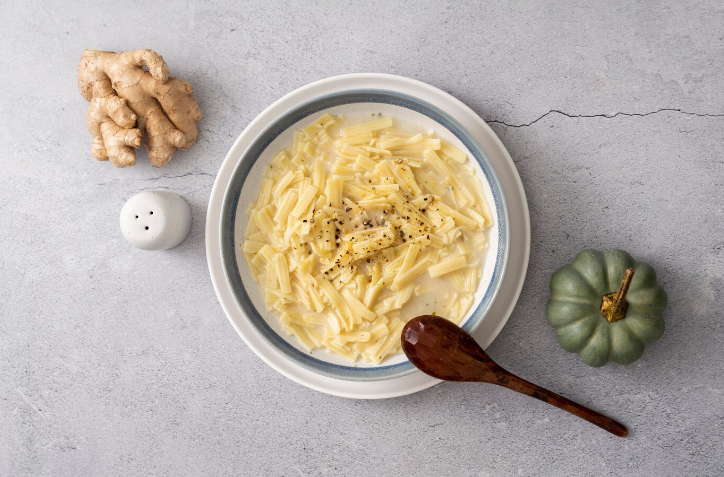 A delicious plate of creamy chicken soup pasta, topped with fresh parsley and grated Parmesan cheese.